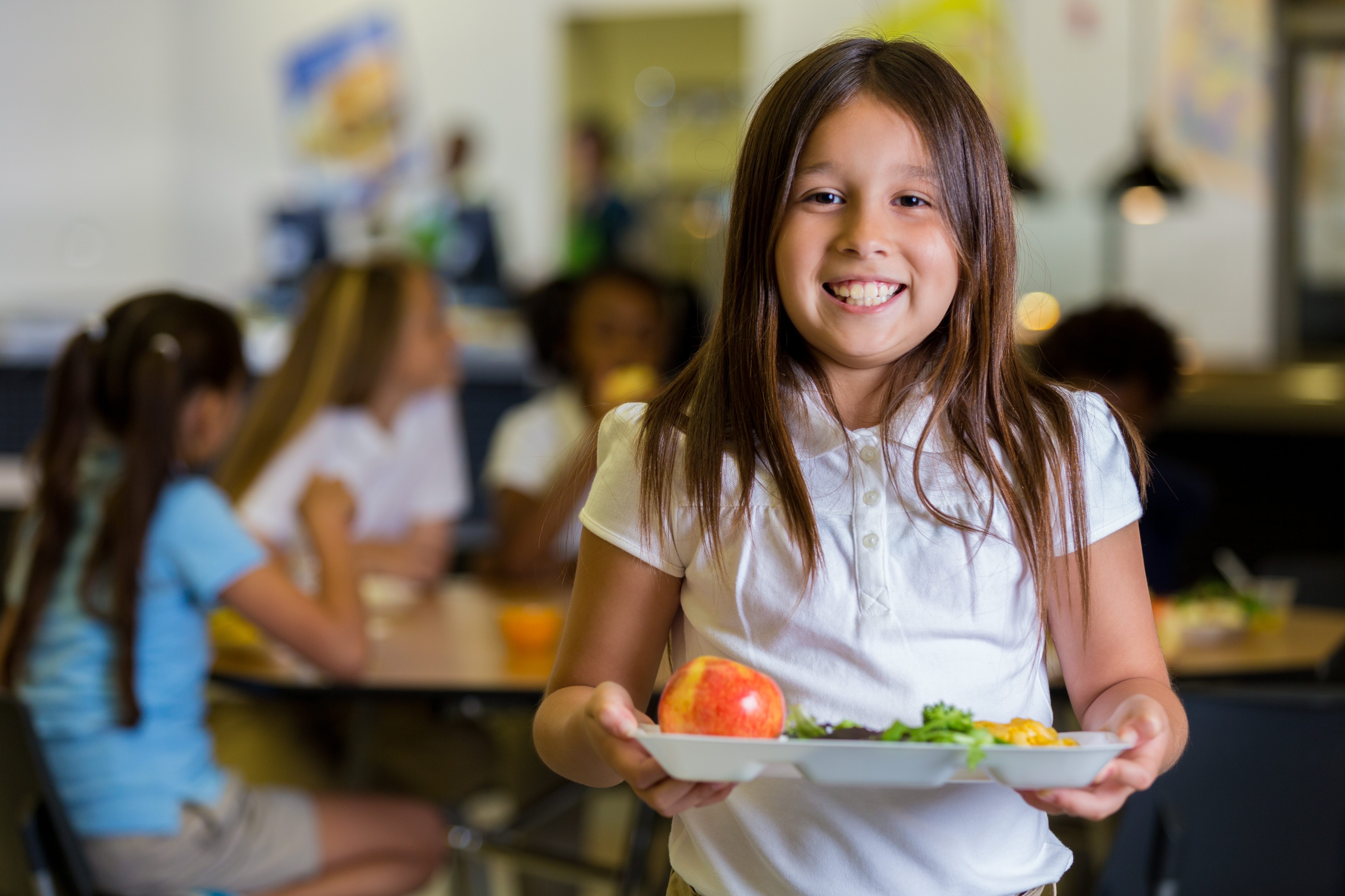 young girl with fruits & veggie lunch tray