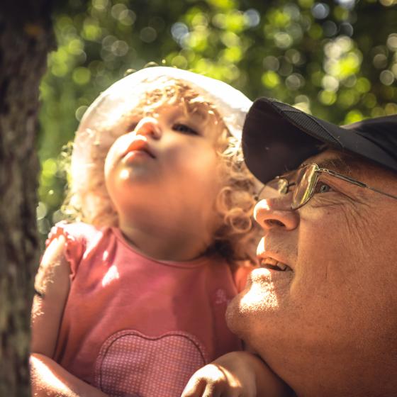 grandfather with toddler with tree