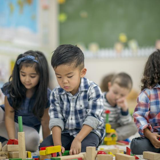 multi-racial toddlers with stacking toys