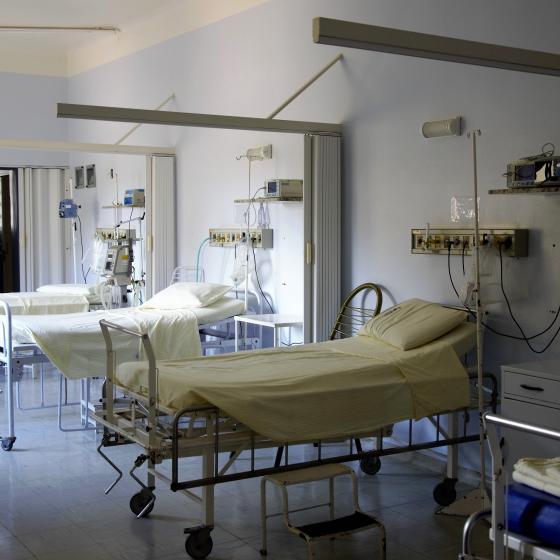 Photo of three empty hospital beds in a clinic