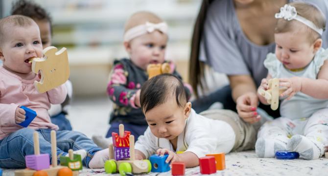 Photo of baby reaching for blocks